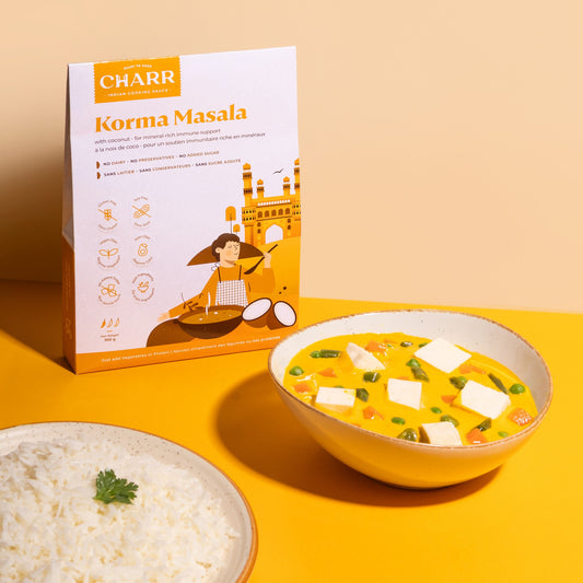 Korma Masala packaging with a bowl of Korma and rice on a yellow background