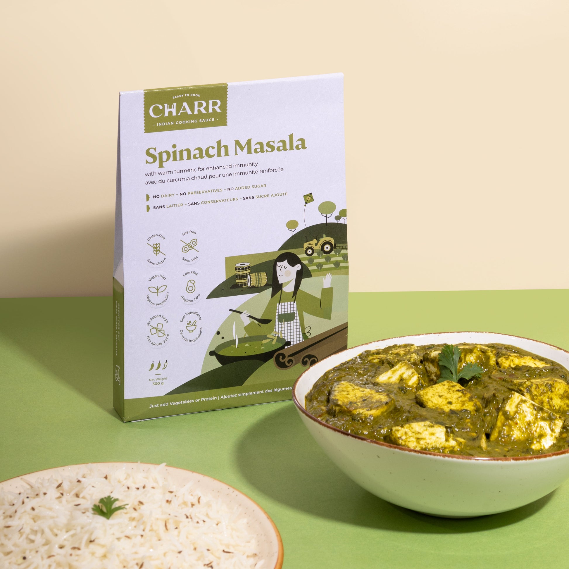 Box of Charr Spinach Masala with a bowl of spinach masala and rice on a green background